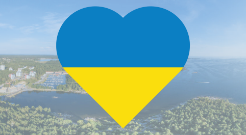 Hjärta med Ukrainas färger mot en bakgrundsbild från drönare över Hammarö kommun.